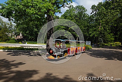 small children`s train waiting for its little passengers in the park Stock Photo