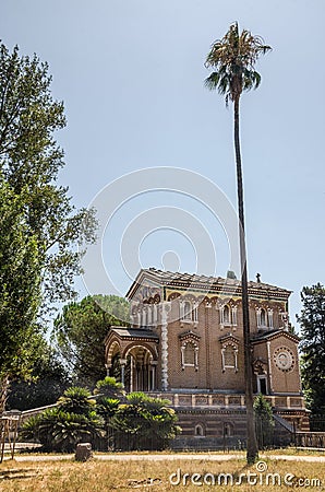 A small church near a palm tree in a park on a Villa Doria-Pamphili in Rome, Italy Editorial Stock Photo