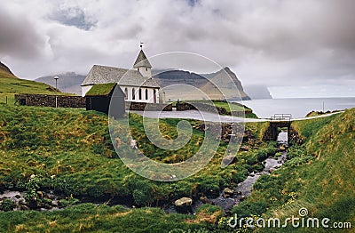 Small village church on the sea shore in Vidareidi, Faroe Islands, Denmark Stock Photo