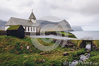 Small village church on the sea shore in Vidareidi, Faroe Islands, Denmark Stock Photo