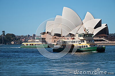 Small city ferry in front of the Sydney Opera House, waterfront and blue sky, Sydney Editorial Stock Photo