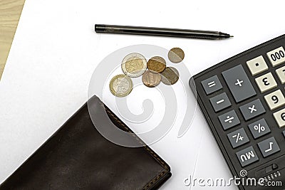 small coins wallet calculator and fountain pen on sheets of white paper on the table concept business budget economy Stock Photo