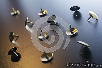 A Small Collection Of Thumbtacks With Reflecting Colors On Dark Ground Stock Photo