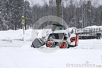 small color tractor clearing snow side view Editorial Stock Photo