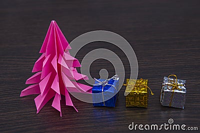 Small colored gifts on the table.pink spruce paper Stock Photo