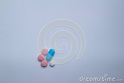 Small colored pills on a neutral background. Free space to write Stock Photo