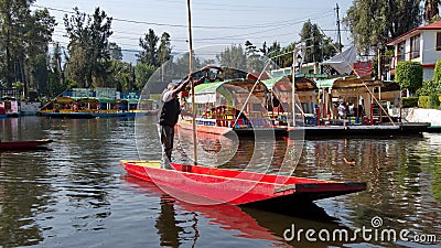 Small, colorful boat being poled at Xochimilco Editorial Stock Photo