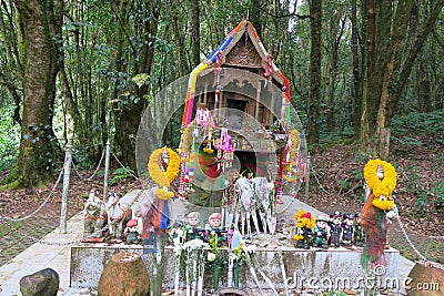 Small but colorful buddhist Shrine in the forest Editorial Stock Photo