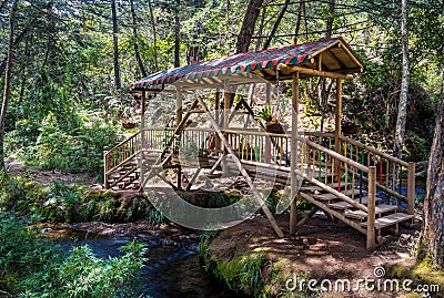 Small colorful covered wooden bridge - Parque Arvi, Medellin, Co Stock Photo