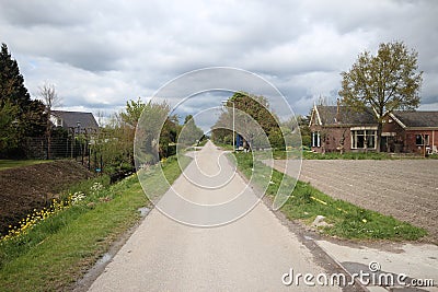 Small country road named Knibbelweg in the lowest polder of western Europe in Zevenhuizen, the Netherlands Editorial Stock Photo
