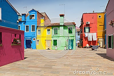 Small, cozy courtyard with colorful cottage / Burano, Venice/ The small yard with colored walls of houses Stock Photo