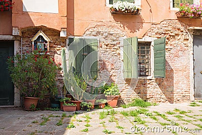 View of the Small, cozy courtyard with colorful cottage / Venice/ The small yard with bright walls of houses Stock Photo