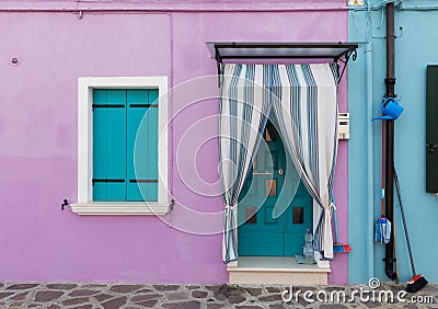 Small, cozy courtyard with violet cottage / Burano, Venice/ The small yard with bright walls of houses Stock Photo