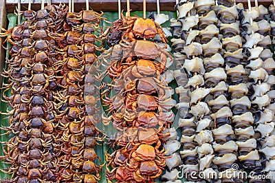 Small crab grilled and shells skewer with bamboo on a banana leaf, Arranged in a row Stock Photo
