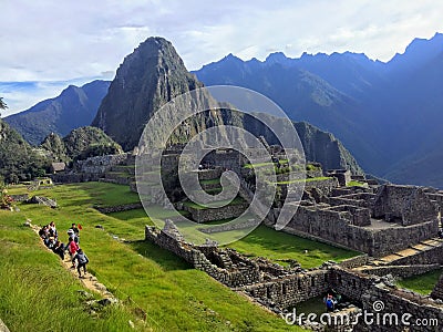 A small crowd of tourists admire the incredible sights of Machu Picchu in Peru. Editorial Stock Photo