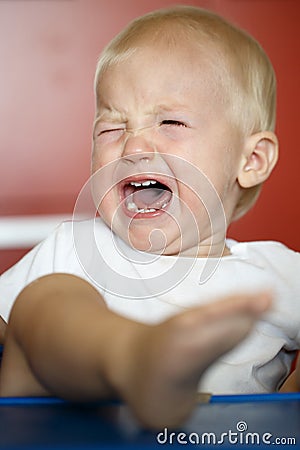 Small, crying and raging toddler having a temper tantrum Stock Photo