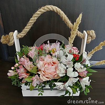 Flowers cute bouquet with roses and alstroemerias pink white green, wooden box Stock Photo