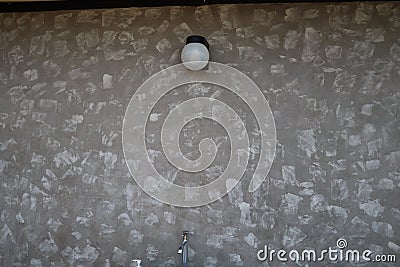 Small cute light on grey wall Stock Photo