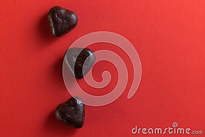 small dark chocolates on red Stock Photo