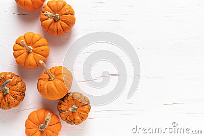 Small decorative pumpkins on white wooden background. Autumn, fall, thanksgiving or halloween day concept, flat lay, top view Stock Photo