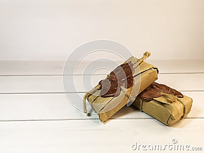 Small delivery box tied with twine with a wax seal on wooden boards Stock Photo