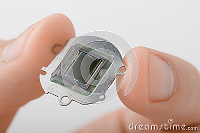 Small digital camera sensor in fingers Stock Photo