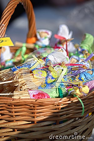 Small dolls from straw in a basket at a fair Stock Photo