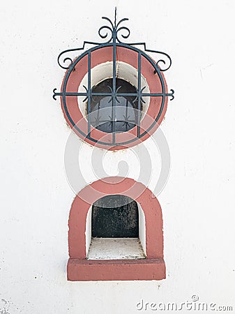 small domed window and another circular window with railing on the facade of the bullring in the village of Coruche Stock Photo