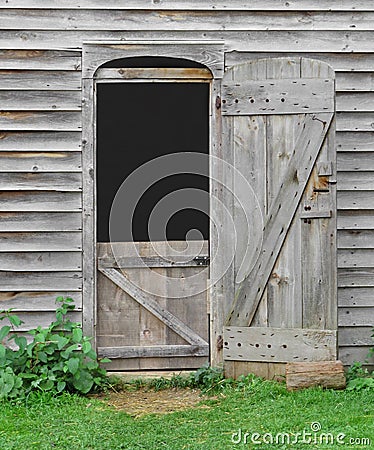 Small doorway in an old wooden barn. Stock Photo