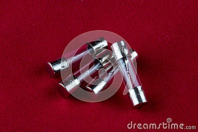 Small Electrical Fuses on a Red Background Stock Photo