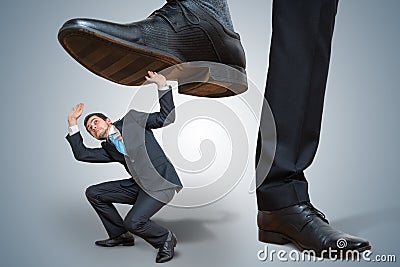 Small employee is abused by big boss Stock Photo