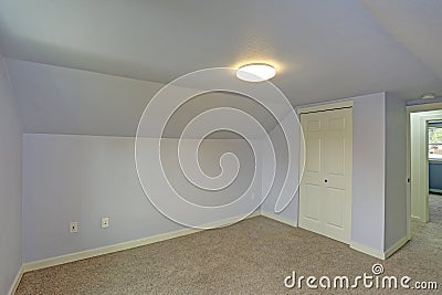 Small empty blue bedroom accented with vaulted ceiling Stock Photo