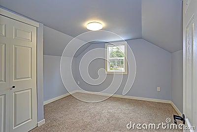 Small empty blue bedroom accented with vaulted ceiling Stock Photo