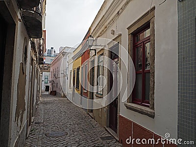 Small empty street with flaking colour houses in Naples Stock Photo