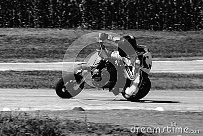 Small engine speed bike rider during practice run in monochrome finish Editorial Stock Photo