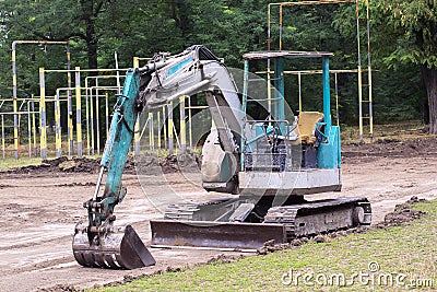 Small excavator at work making garden pond Stock Photo