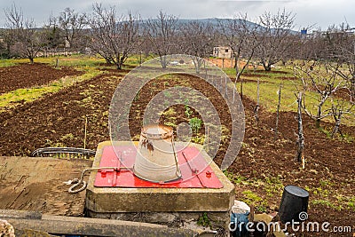 Small farm in Croatia vegetable field, orchard, well in spring Stock Photo