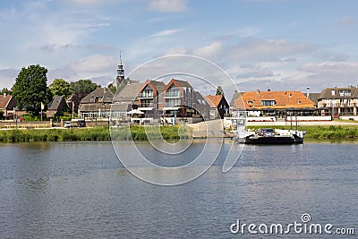 Small ferry crossing river Meuse near Dutch village Broekhuizen Editorial Stock Photo