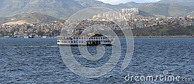 A small ferry on the waves Aegean sea and a picturesque panorama Stock Photo