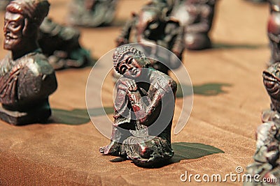 Small figurines of Buddha, Ganesha, Frog in the market of bazaars in India. Souvenir gift India Stock Photo