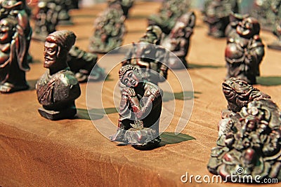 Small figurines of Buddha, Ganesha, Frog in the market of bazaars in India. Souvenir gift India Stock Photo