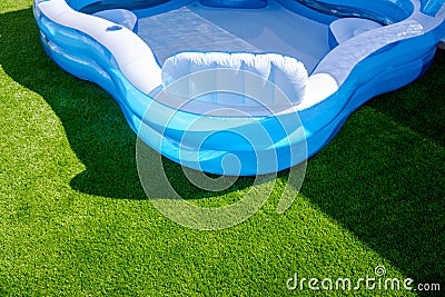 A small fillable plastic, rubber pool in an outdoor garden Stock Photo