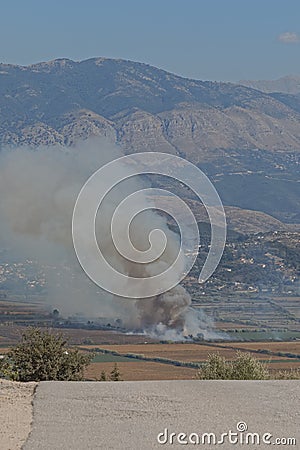Small fire in valley fire view from hill above Saranda city in Albania Stock Photo