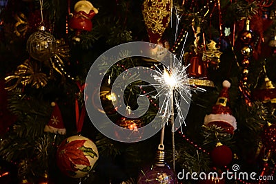 Small fireworks in front of christmas tree on New Year`s Eve Stock Photo