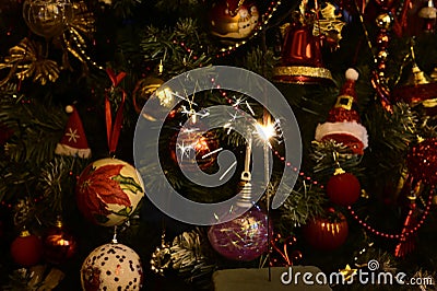 Small fireworks in front of christmas tree on New Year`s Eve Stock Photo