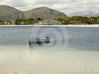 Small fishing boat lies alone in a bay Stock Photo