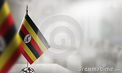 Small flags of the Uganda on an abstract blurry background Stock Photo