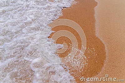 Small foam wave on sea close with beach Stock Photo