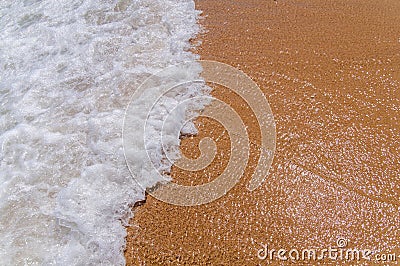 Small foam wave on sea close with beach Stock Photo
