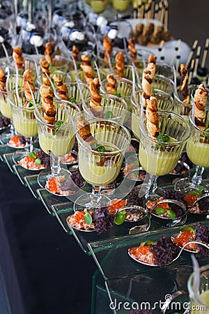 Fresh and tasty snack dishes in glasses, caviar served with micro green and salad, celebration party banquet, gourmet food fashion Stock Photo